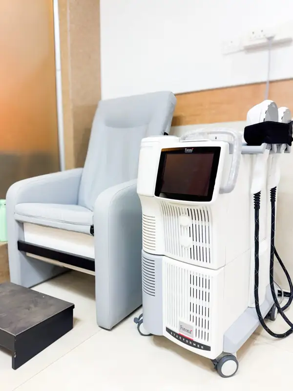 Fotona StarFormer with its two applicators beside a reclining chair